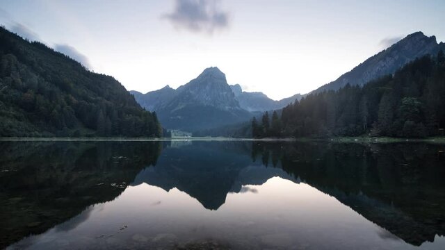 Sunset time lapse of lake Obersee in Glarus, Switzerland with a summer glow and calm reflection