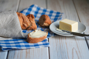 Baguette and butter on a wood table
