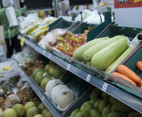 Various fruits and vegetables sold in the food zone of the mall. Side view
