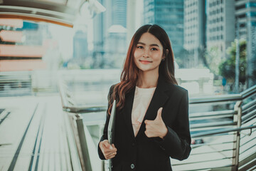Fototapeta premium Portrait of young beautiful businesswoman standing outdoor.