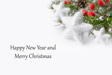 Christmas card with a green branch of a Christmas tree with red berries and a pine cone on a white background.