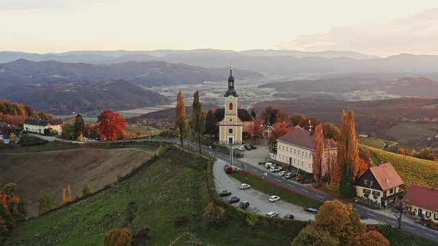 Aerial view of Austrian vilage Kitzeck im Sausal on vineyard. Shoot of Church on the top of grape hill. Trawel destination.