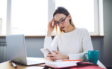 Administrative assistant messaging via smartphone in office