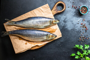 whole herring fresh fish or salted seafood ready to cook and eat on the table pescetarian diet for healthy meal snack outdoor top view copy space for text food background rustic image 