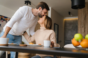 Beautiful young happy couple having breakfast