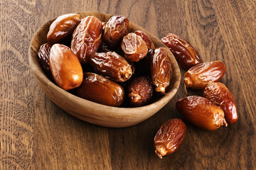Dried dates on wooden background.