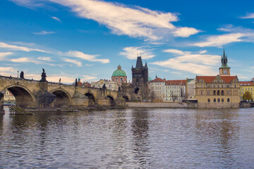 Sunny view of Old Prague bridge and river at sunset, czech republic
