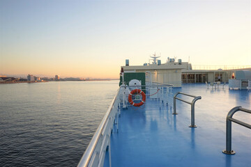 Panoramic view of Kobe port from ferry boat with sunrise in Hyogo, Japan -...