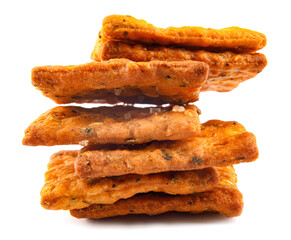 A stack of crispy breads with coarse salt and spices is isolated on a white background.