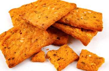 Cookies with crumbs with coarse salt and spices on a white background.