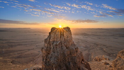 Beautiful sunrise landscape with sunburst over Machtesh Ramon (Ramon Crater), Negev Desert, Israel