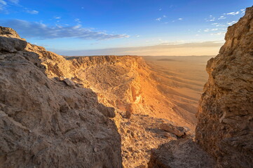 Fototapeta na wymiar Beautiful landscape with sun light hitting the cliffs of Machtesh Ramon (Ramon Crater), Negev Desert, Israel