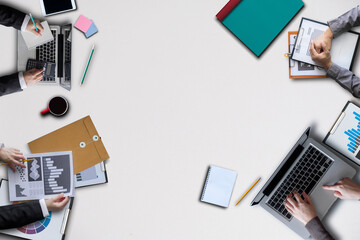 Man typing on laptop computer with white blank screen over white office desk table with cup of coffee. Top view with copy space, flat lay.