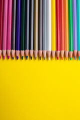 Color pencil, empty place for text or drawing on yellow background. creative art and education concept.
