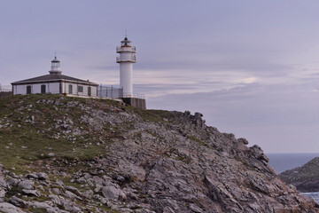 Tourinan Lighthouse in Muxia, Galician coast, Spain.  Twice a year, at the beginning of spring and the end of summer, Cape Touriñan becomes the last shadow for the sunset in continental Europe.

