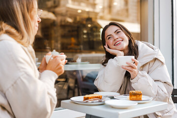 Two attractive young women having lunch at the cafe