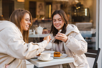 Two young girls using smart phone