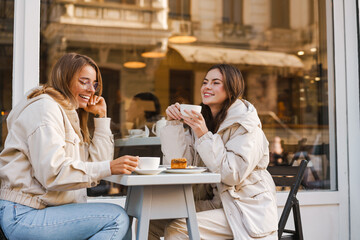 Two attractive young women having lunch at the cafe