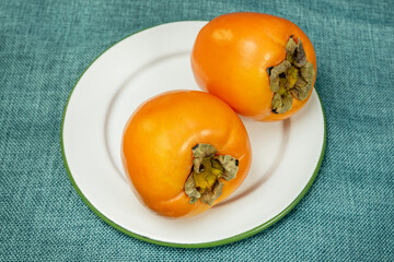 white plate with persimmons