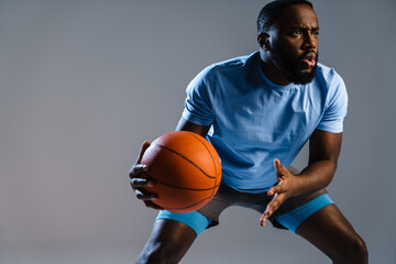 Young african basketball player with basketball