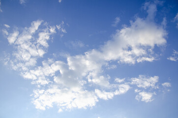 Blue sky background with abstract white clouds