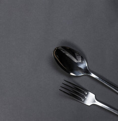 Fork and spoon on black background