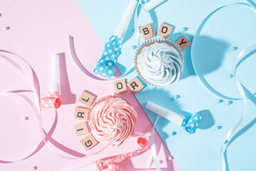 Fototapeta premium gender party. boy or girl. two cupcakes with blue and pink cream, celebration concept when the gender of the child becomes known