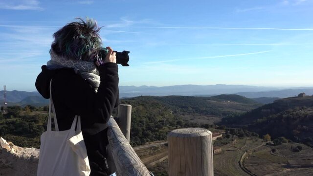 Traveler taking pictures in beautiful landscape over mountains