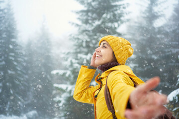 inspired traveler girl enjoying snowy winter walk in forest, great pleasure in nature, feeling good concept, follow me hand - 401406199