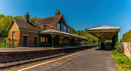 A view across a station on the Bluebell railway in Sussex, UK on a sunny summer day