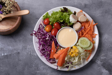 Mixed green salad, thick dressing in white plate