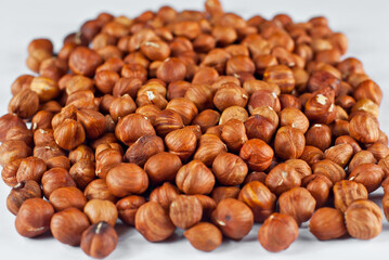 Peeled hazelnuts close up. Texture of nuts. Lots of nuts in a pile.