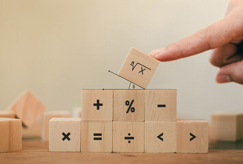 Math symbols written on the wooden blocks of a businessman With calculations with ideas A concept, a difficult problem or a mathematical solution - obrazy, fototapety, plakaty