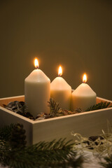 Wooden box christmas centerpiece. Simple and small home decoration with candles in wooden box.
