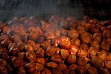 Peeled hazelnuts close up. Texture of nuts. Lots of nuts in a pile. Contrasting dramatic light as...