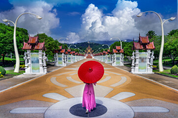 Thai woman with  umbrella walks to see Ho Kham Luang Pavilion at Royal Park Rajapruek in Chiang...