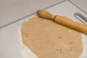 Fototapeta na wymiar Bakery products. Christmas cookies. Dough on a cutting board. Rolling pin. Cooking.