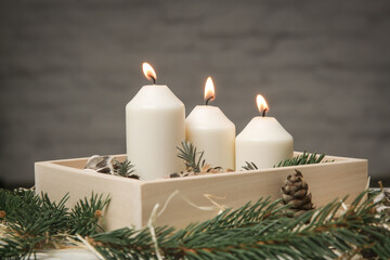 Wooden box christmas centerpiece. Simple and small home decoration with candles in wooden box.
