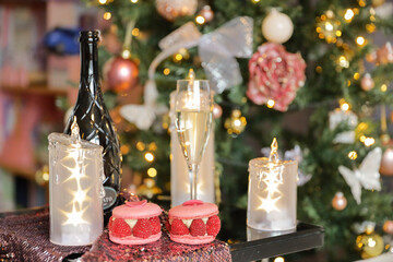 Three candles with stars, bottle of wine with glass of champagne, Christmas tree, xmas time decoration