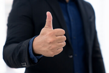 Businessman showing thumbs up.