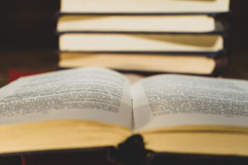 close-up of an old book open on the library desk selective focus and shallow depth of field. Reading books.