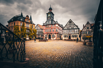 Half-timbered houses in Germany Heppenheim. Historic city center, marketplace without people. Wheel house, taken on the day with rain clouds - obrazy, fototapety, plakaty