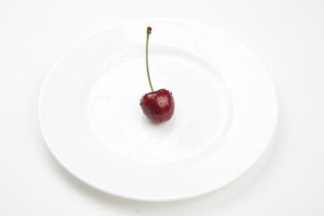 juicy cherry berries lie on a white plate. healthy food for breakfast. fruits of vegetation. fruit dessert