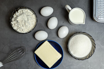 Ingredients for making waffles at home. Eggs, flour, milk, sugar, condensed milk, and a wire whisk. Step-by-step instructions. step 1.