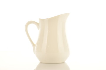 One white ceramic milk jug isolated on white, close-up.