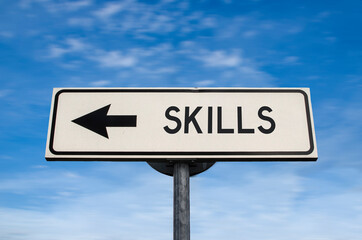 Skills road sign, arrow on blue sky background. One way blank road sign with copy space. Arrow on a pole pointing in one direction.