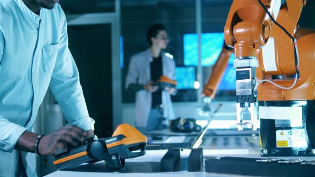 Closeup of industrial robot gripping microchip