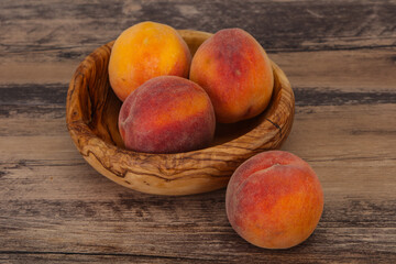 Peach heap in the wooden basket