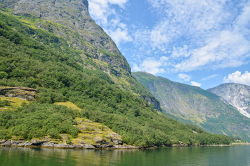 Amazing nature view with blue waters and tree covered rocks jutting out of water one of the most beautiful fjords in Norway, Sognefjord 