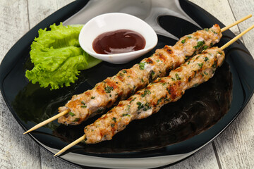 Minced pork skewer kebab with sauce